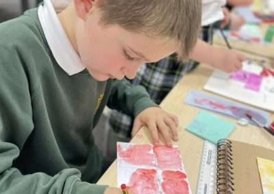 Class 4 Art have been exploring different techniques which can be applied to watercolours to create unusual effects .