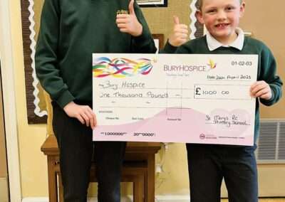 Bury Hospice came into school today to present us with a cheque to say thanks for our wonderful fundraising for them .